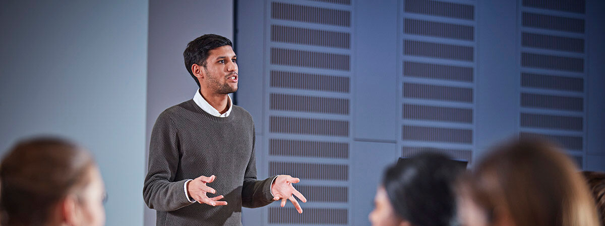 Lecturer talking to students